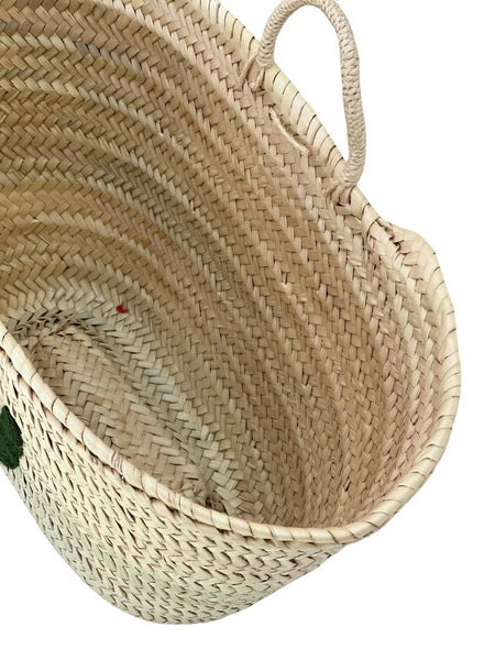 Woven basket with handles on a white background