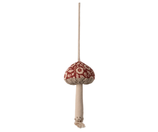 Decorative mushroom ornament with a red cap and beige stem on a white background