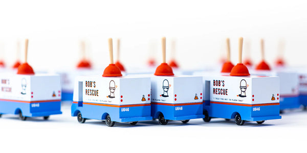 Model trucks labeled 'Bob's Rescue' with red smokestacks on a white background