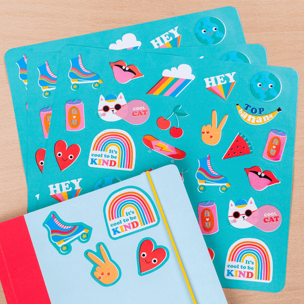 Colorful sticker sheets with various designs on a wooden surface