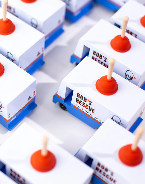 Small model cars with 'Bob's Rescue' branding on a white surface