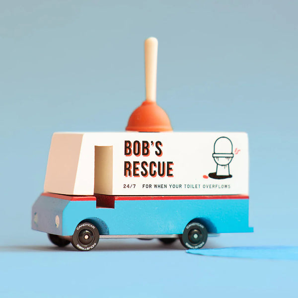 Toy truck with a plunger on top labeled 'Bob's Rescue' against a light blue background