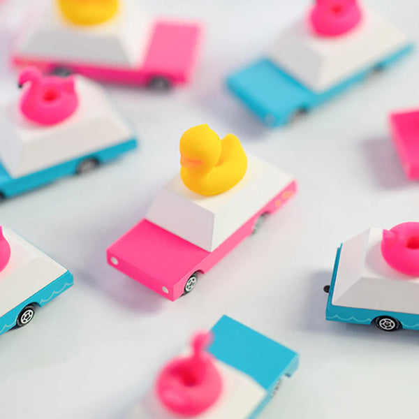 Colorful toy cars with duck-shaped toppers on a white background