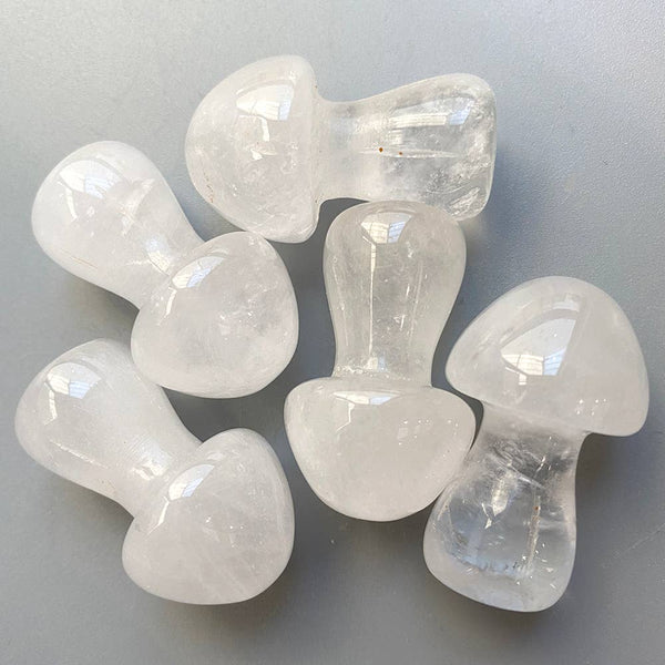 Clear quartz crystal mushrooms on a grey background