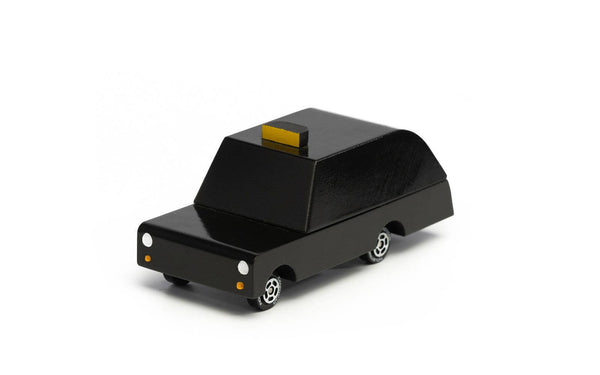 Black toy car with a yellow light on a white background