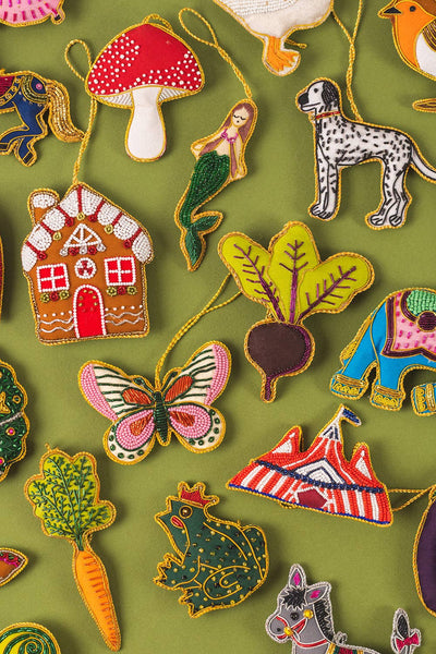 Collection of colourful beaded decorations on a green background