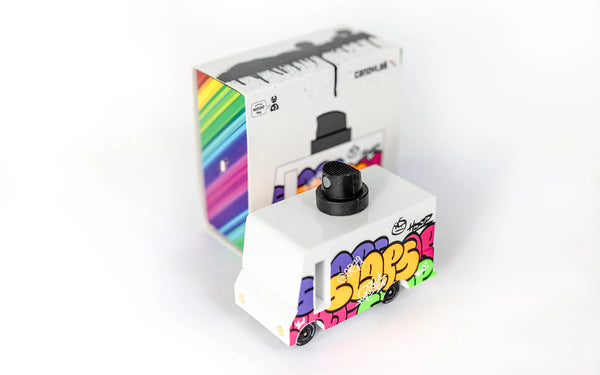 Colourful wooden toy van with graffiti design on a white background