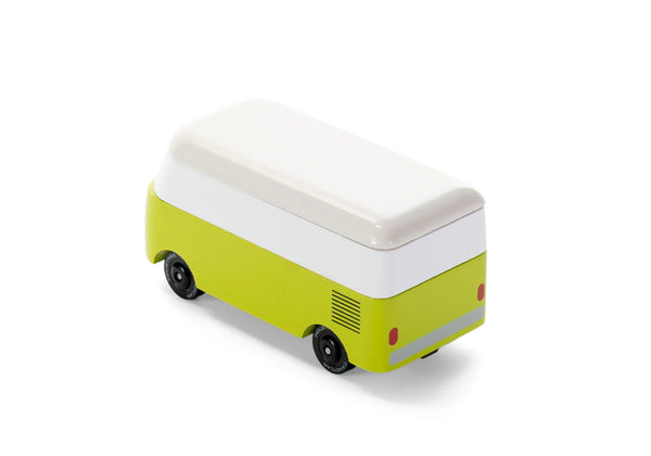 Small green and white wooden toy vehicle on a white background