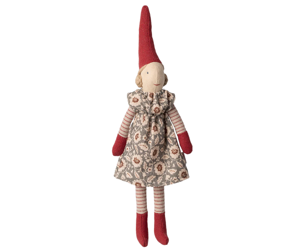 Stuffed pixy toy with a red hat and floral dress on a white background