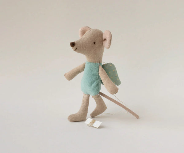 Stuffed toy mouse with fairy wings on a plain background