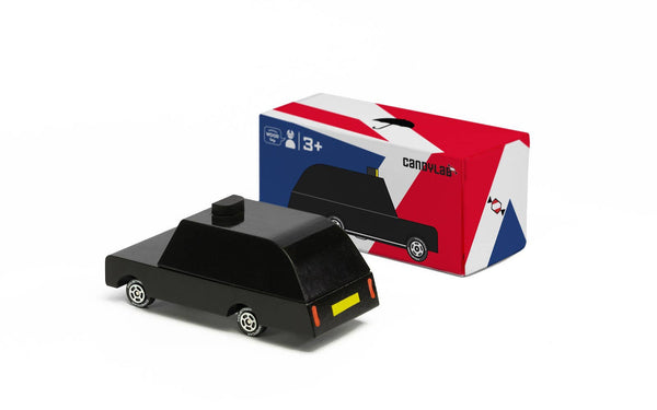 Black toy car with a colourful box on a white background