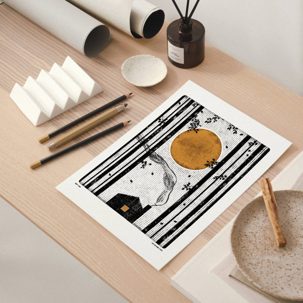 Art print on a wooden table with stationery items