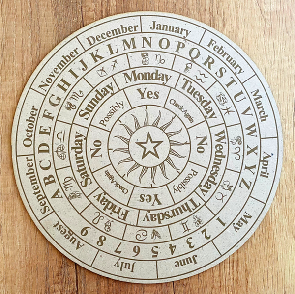 Circular calendar with symbols on a wooden surface