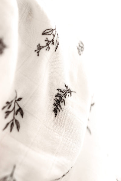 White fabric with black floral patterns on a white background