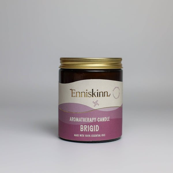 Enniskinn aromatherapy candle labeled 'Brigid' on a gray background