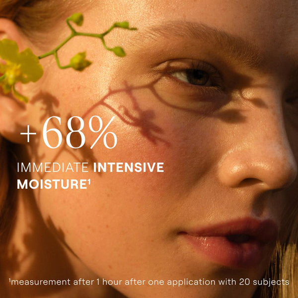 Close-up of a person's face with a plant leaf, highlighting immediate intensive moisture increase.