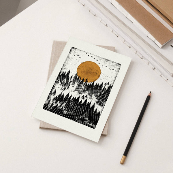 Greeting card of a forest and sun with a pencil on a light surface