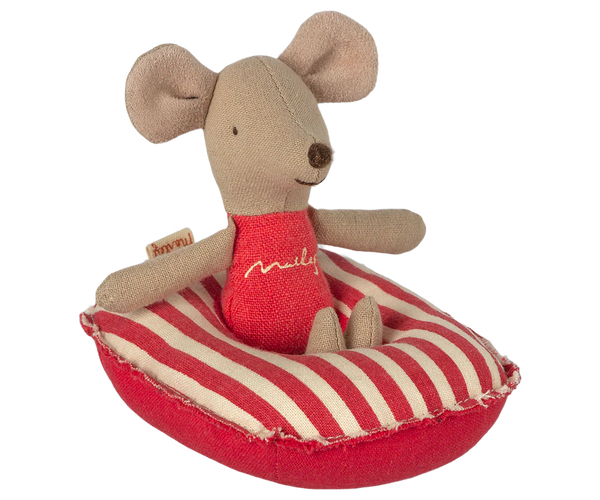 Stuffed mouse toy in a red and white striped boat on a white background