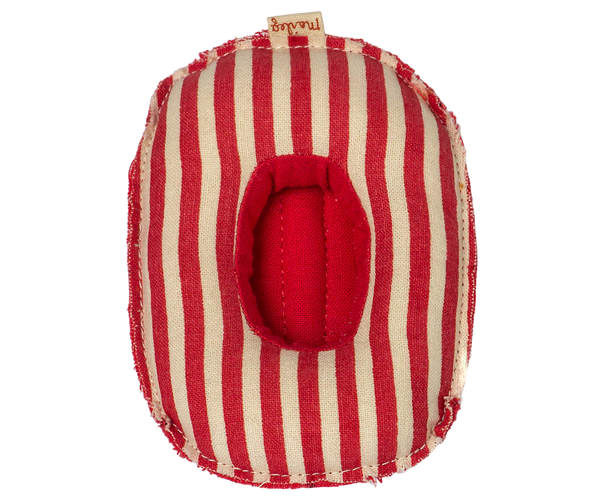 Red and white striped toy boat on a white background