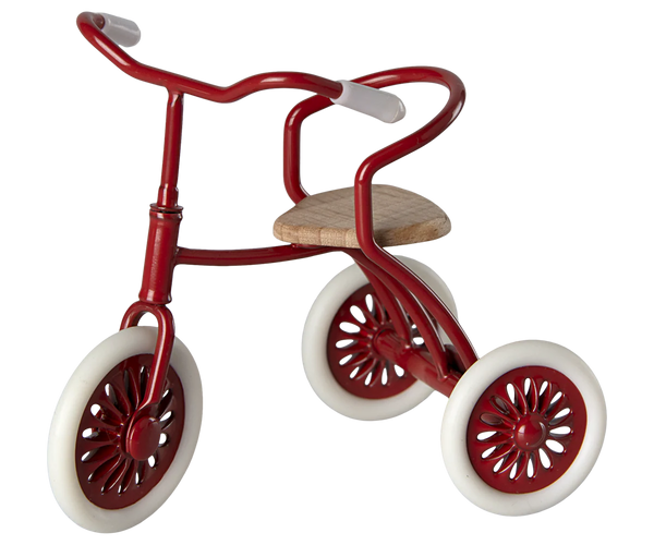 Red tricycle with white wheels on a white background