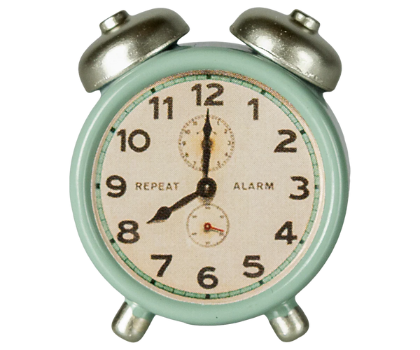 Vintage-style alarm clock with a light green casing and metallic bells on a white background.