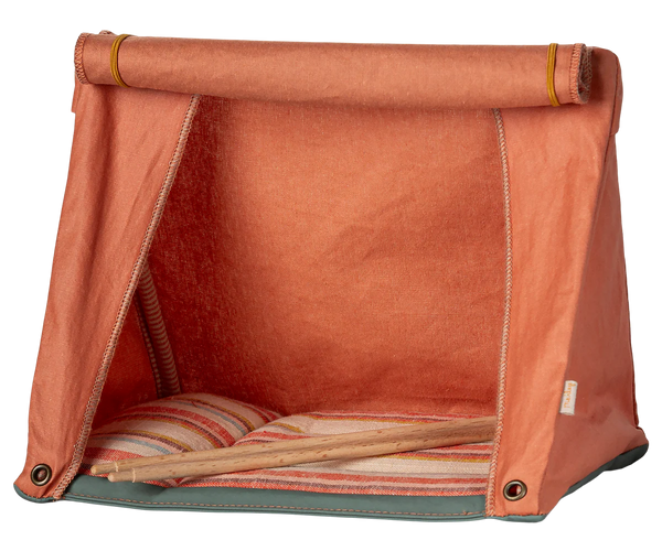 Orange toy tent with striped cushion on a white background
