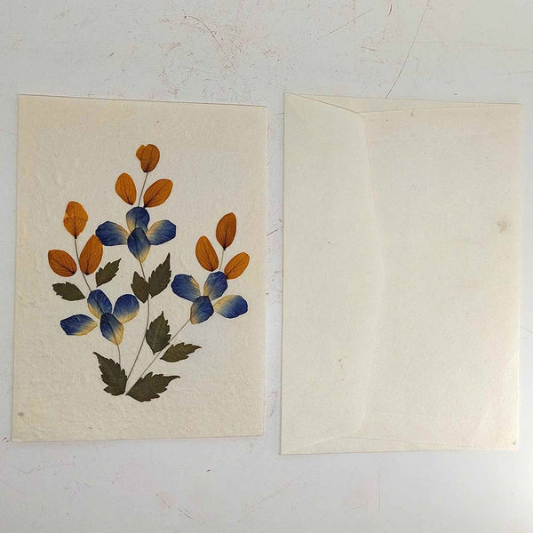 Decorative card with floral design on the left and plain envelope on the right against a white background