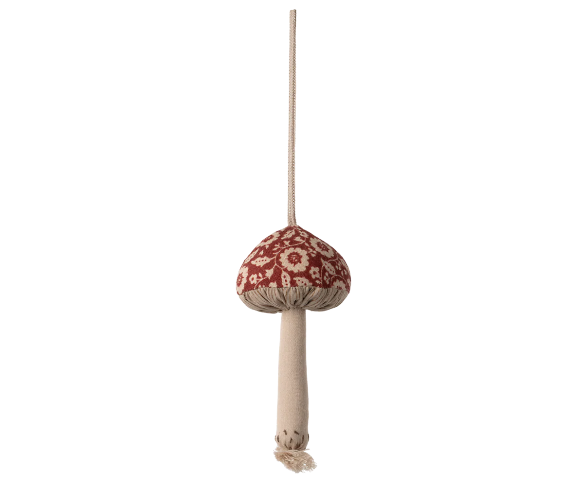 Decorative mushroom ornament with a red cap and beige stem on a white background