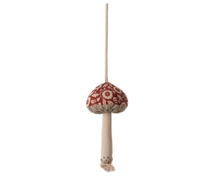 Decorative mushroom ornament with a red cap and beige stem on a white background