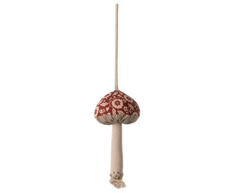 Decorative mushroom ornament with a red cap and beige stem on a white background