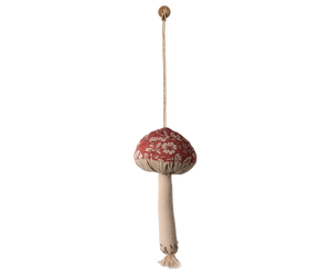 Decorative hanging mushroom with floral pattern and beige tassel on a white background