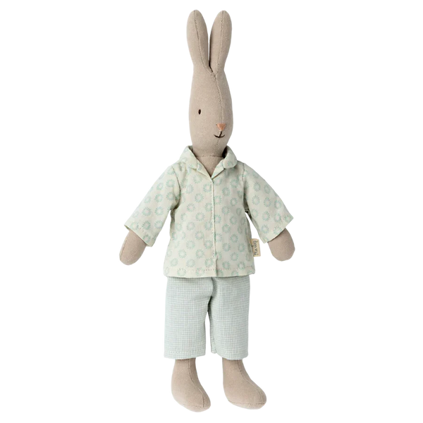Stuffed rabbit toy wearing a light green outfit with small patterns on a white background