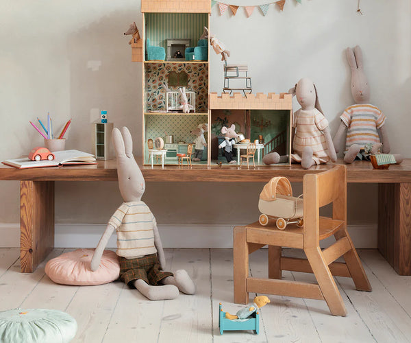 large soft toy rabbits and small mice in a child's play setting