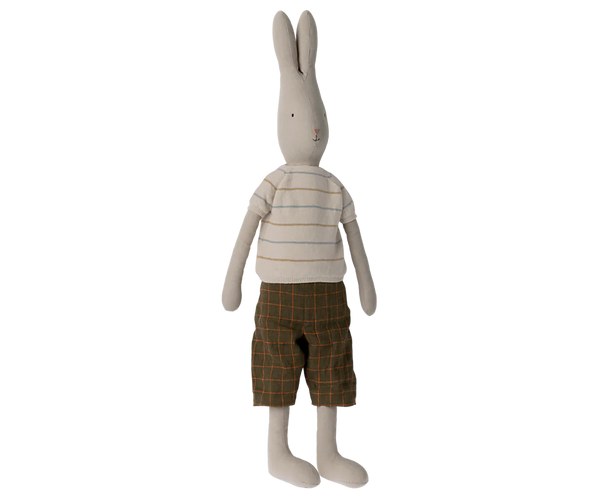 Soft toy bunny wearing a beige striped t-shirt and brown check shorts against a white backgrond