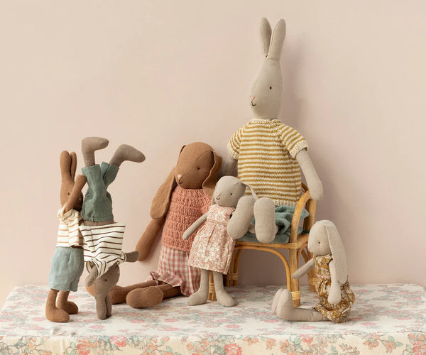 Soft toy bunnies in a play setting 