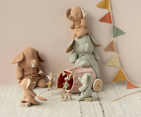 Soft toy elephants and mice in a play setting