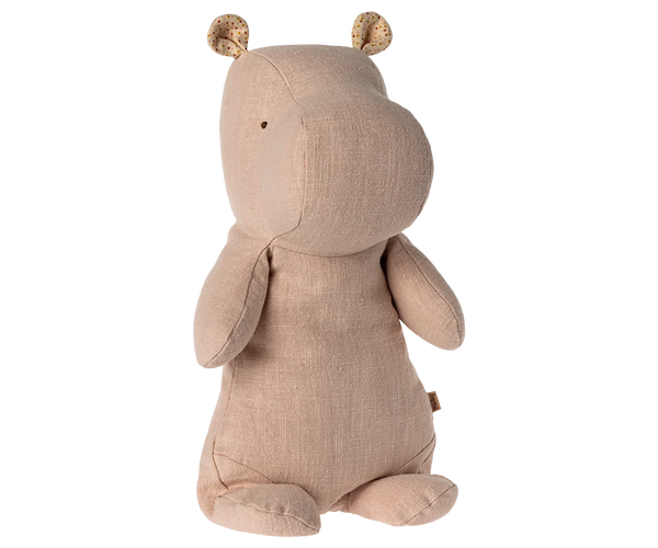 A plush hippo toy made of textured pale pink fabric, featuring small patterned ears and a tiny black embroidered eye, shown from the back on a white background.