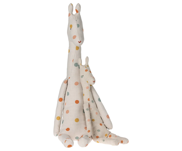 A plush stuffed animal set featuring a tall giraffe and a smaller one nestled in its neck, both in an off-white fabric with scattered orange, yellow, pink and blue polka dots, set against a plain white background.