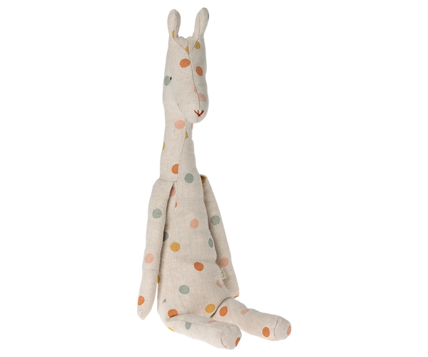 A handmade fabric giraffe plush toy in a cream linen-like material with multicolored polka dots, sitting against a plain white background.