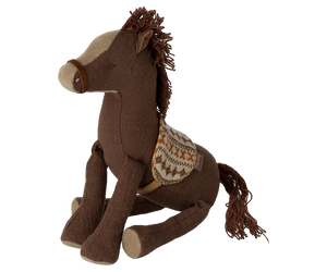 Brown plush horse toy with a saddle on a white background