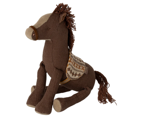 Brown plush horse toy with a saddle on a white background