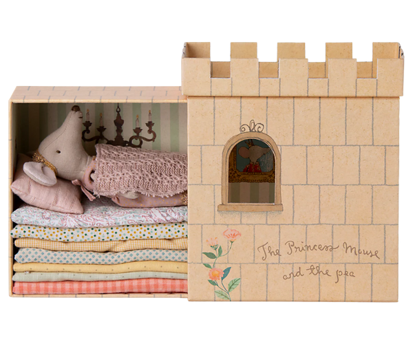 Wooden toy castle with plush toys and fabric layers on a white background
