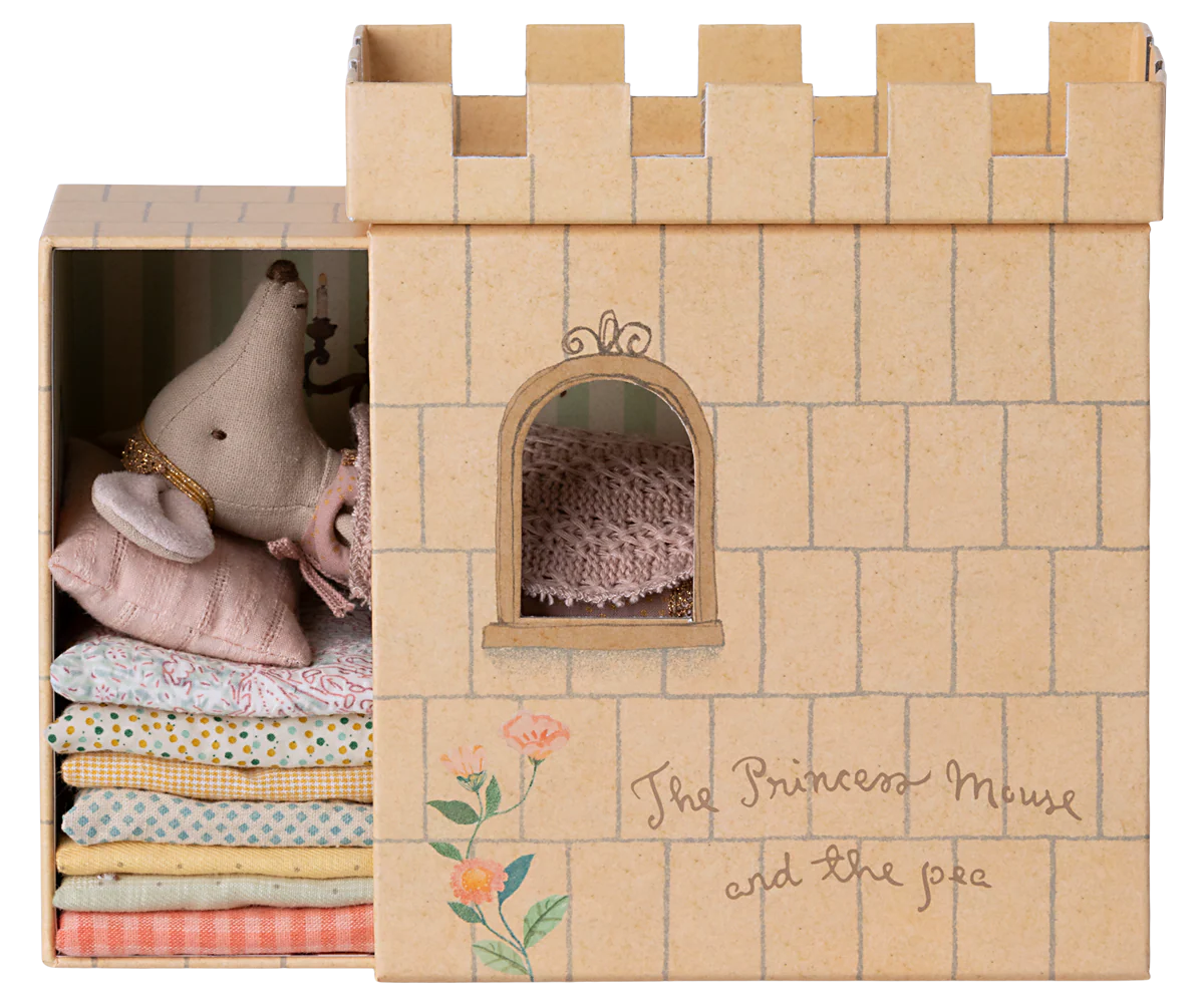 Cardboard castle toy with plush toys and fabric inside, branded 'The Princess Mouse and the Pea'.
