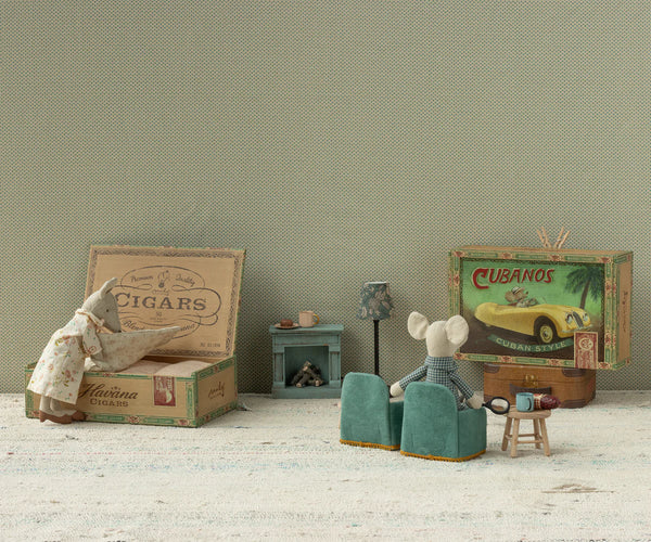 Miniature diorama with two mice in a room with vintage furniture and decor.