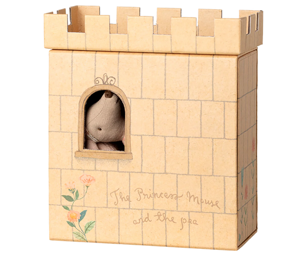 Wooden castle toy with a small plush toy inside, on a white background