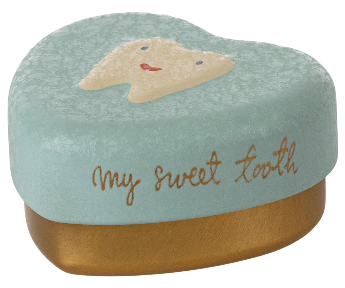 Tooth-shaped container with a face design and 'my sweet tooth' text on a mint green background.