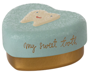 Tooth-shaped container with a face design and 'my sweet tooth' text on a mint green background.