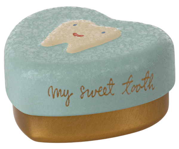 Tooth-shaped container with a face design and 'my sweet tooth' text on a mint green background.