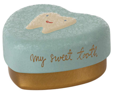 Tooth-shaped container with a face design and 'my sweet tooth' text on a mint green background.