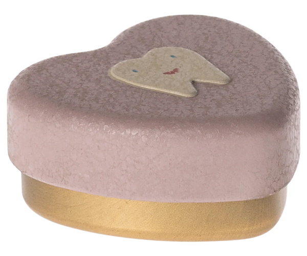 Heart-shaped heather pink box with a gold base and a small tooth illustration on a white background